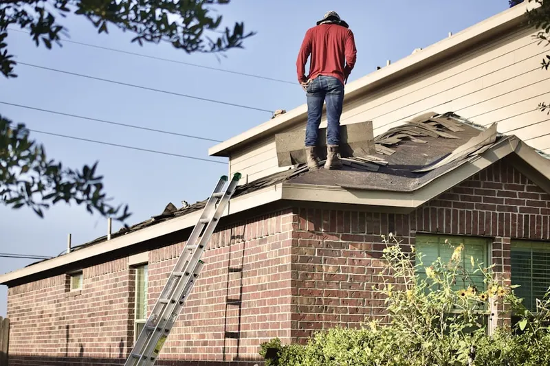 Professional roofer working on a residential roof in Washington Mills